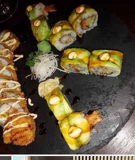 Bunte Sushi-Rollen auf Schiefer